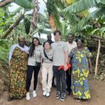 The Safi co-founders (centre, L-R: Miraal Kabir, Daria Margarit, and Martin Turuta) meet with Rwandan dairy farmers